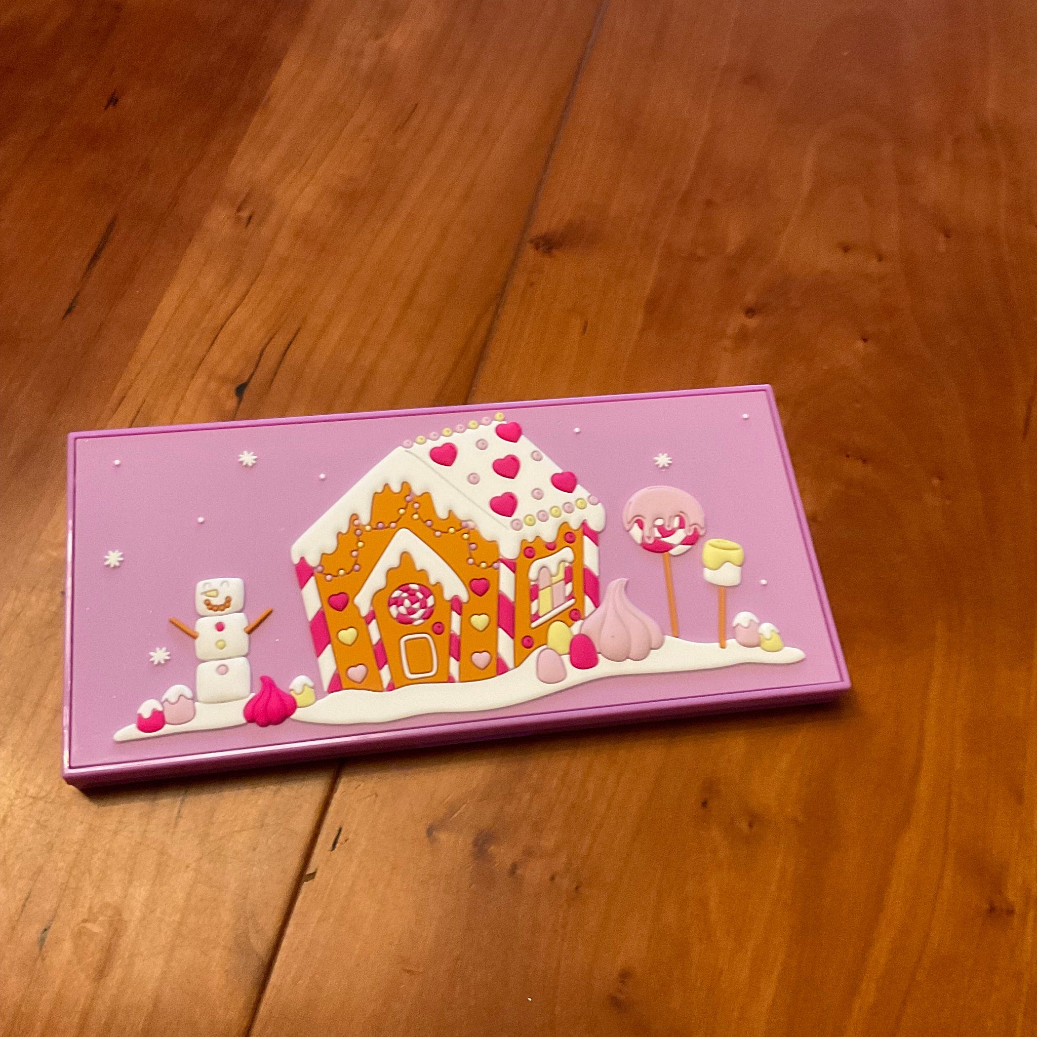 Front view of I Heart Revolution Marshmallow Wonderland palette with pastel pink packaging and 12 colorful eyeshadow shades