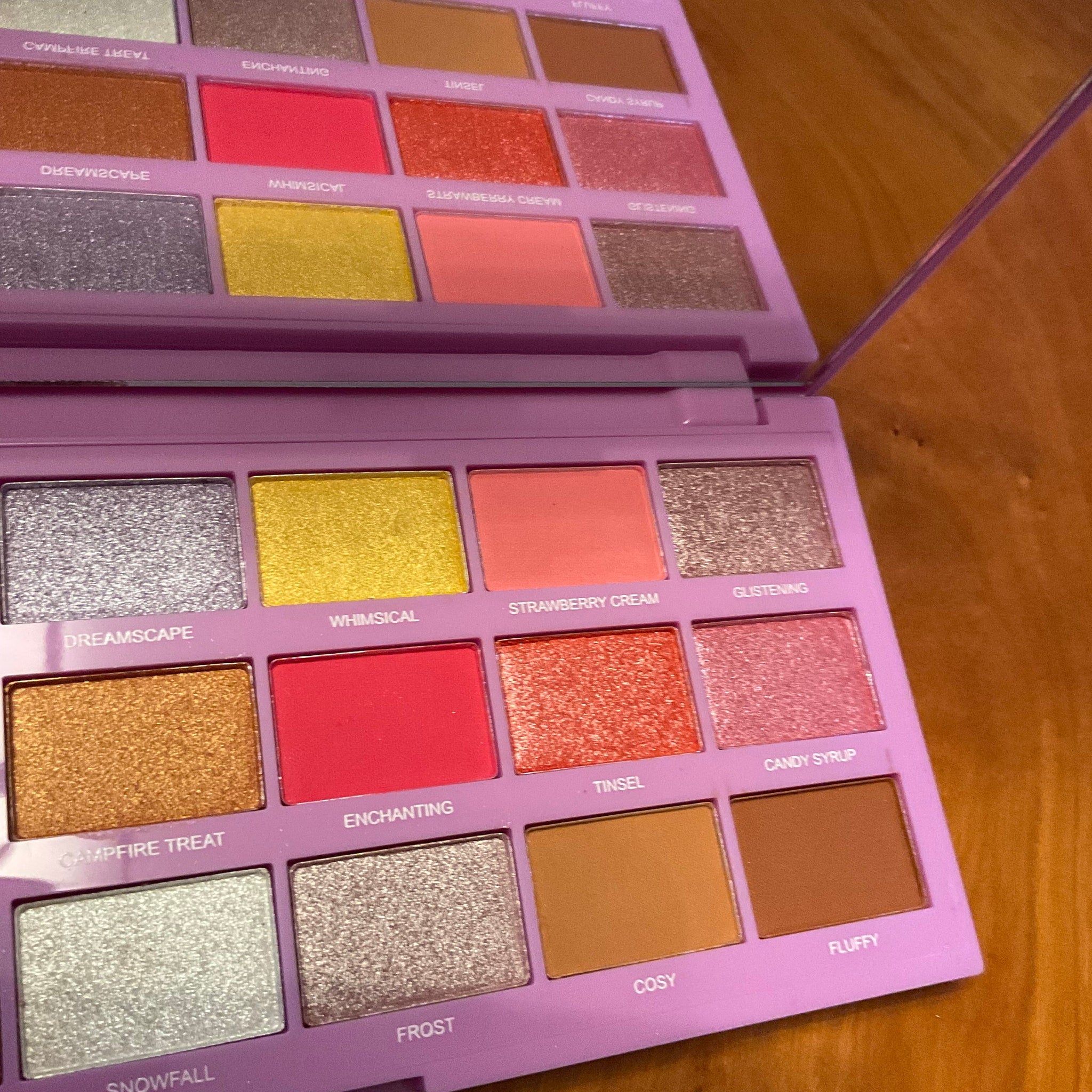 Side view of Marshmallow Wonderland palette showing pastel pink packaging and open shadow pans in soft matte and shimmer shades