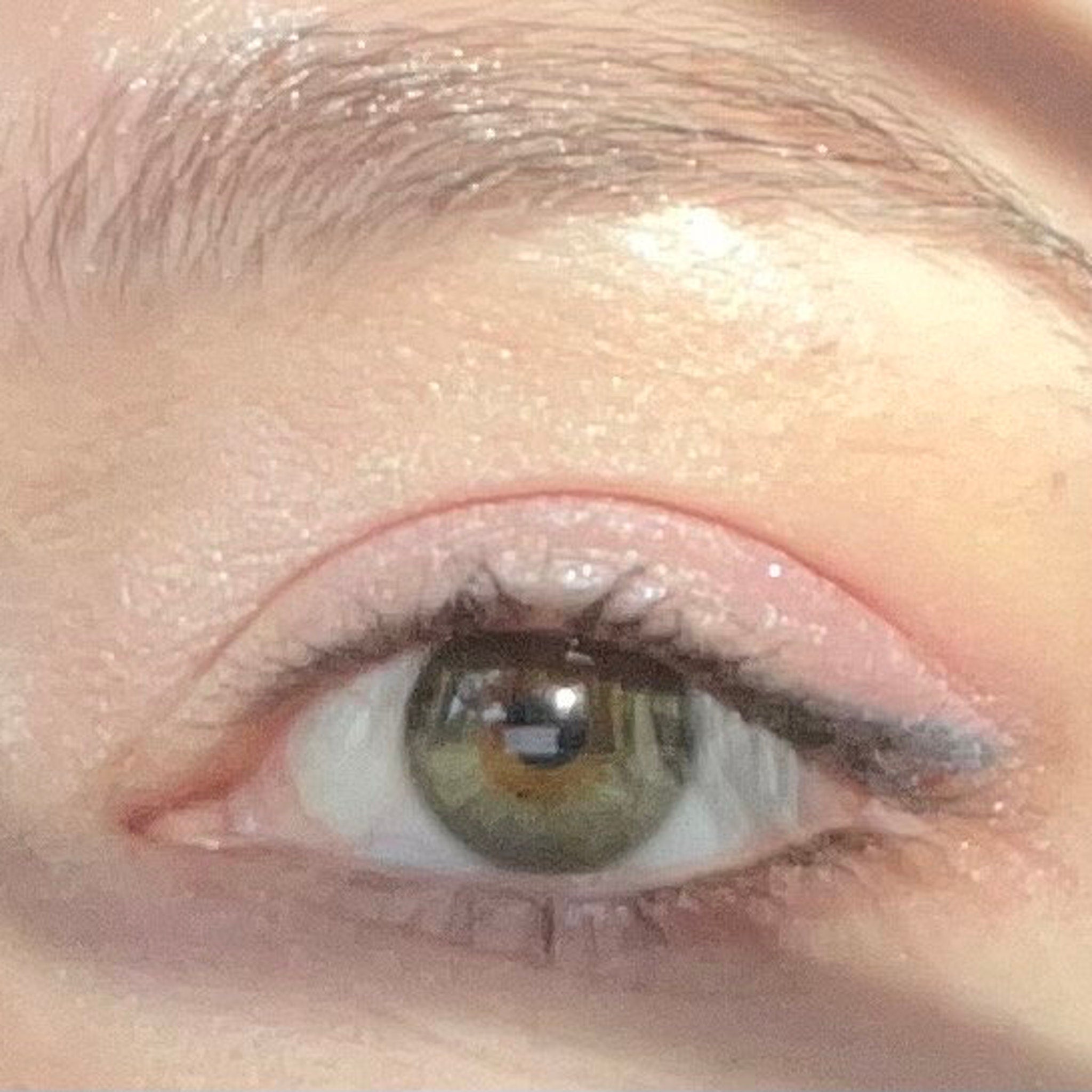 Eye makeup with pink eyeshadow and black eyeliner, visible eyelashes and eyebrow.