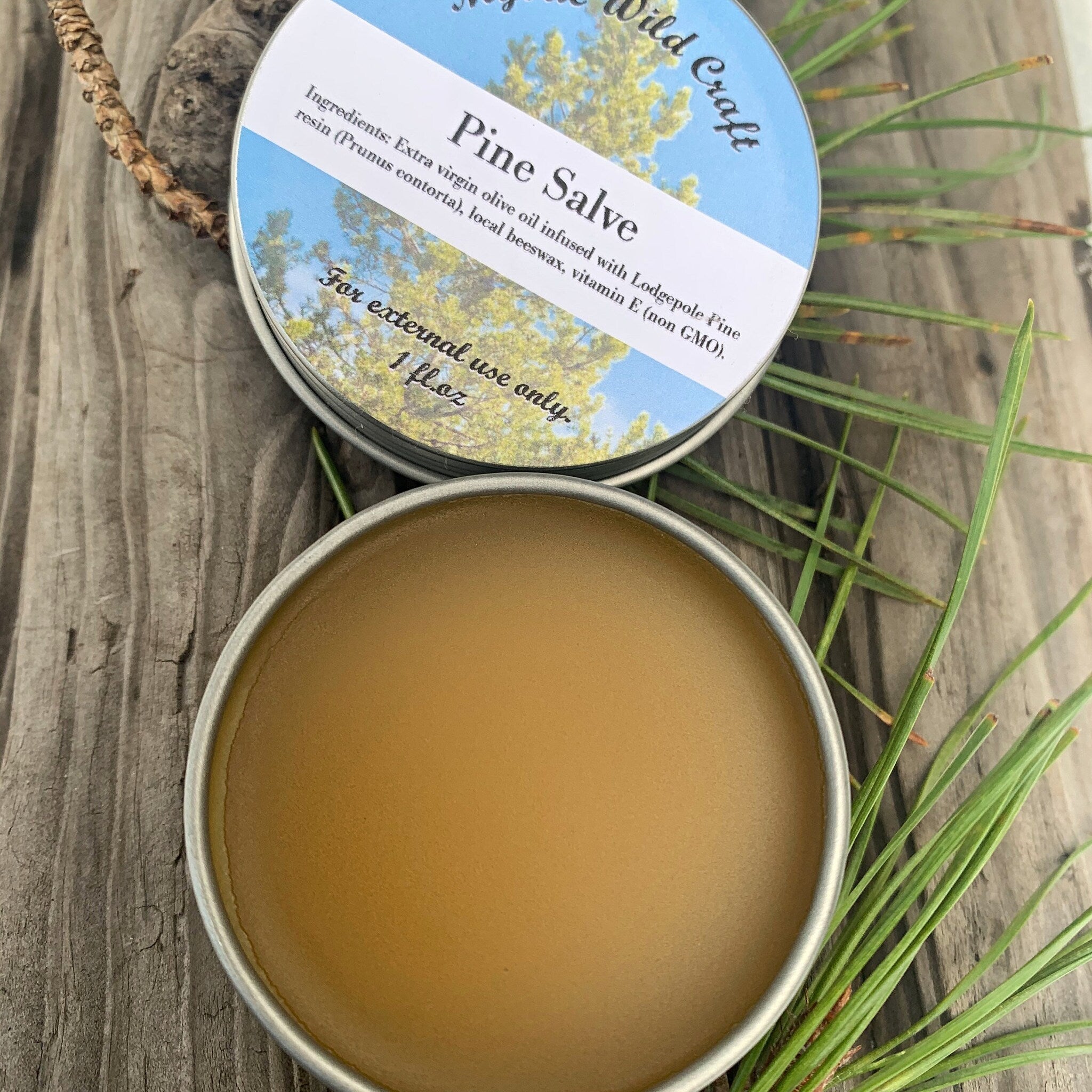Close-up of amber glass jar containing Canadian pine salve with rustic wooden lid and creamy texture
