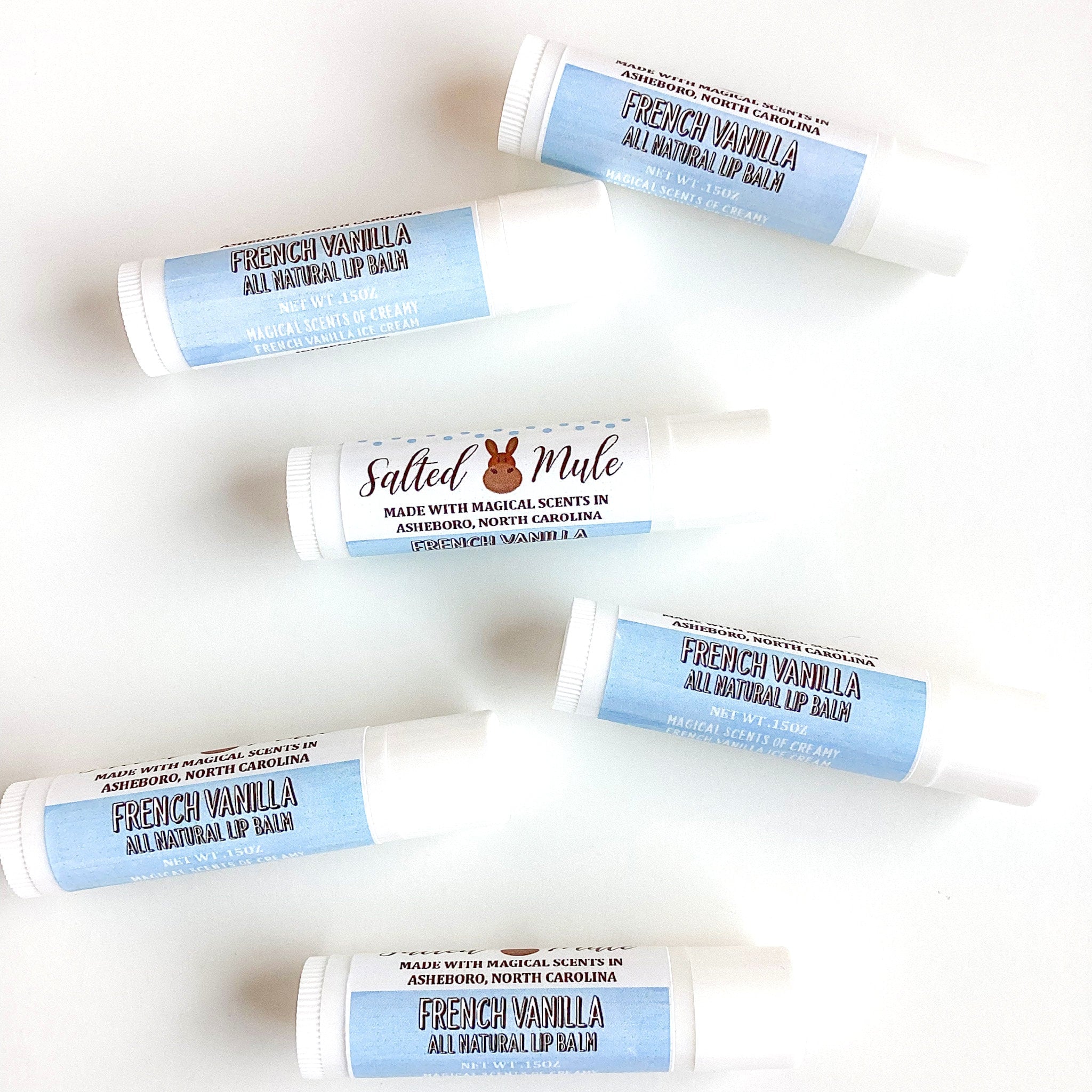 Lip balm tubes with white and blue labels, French Vanilla text, and white background