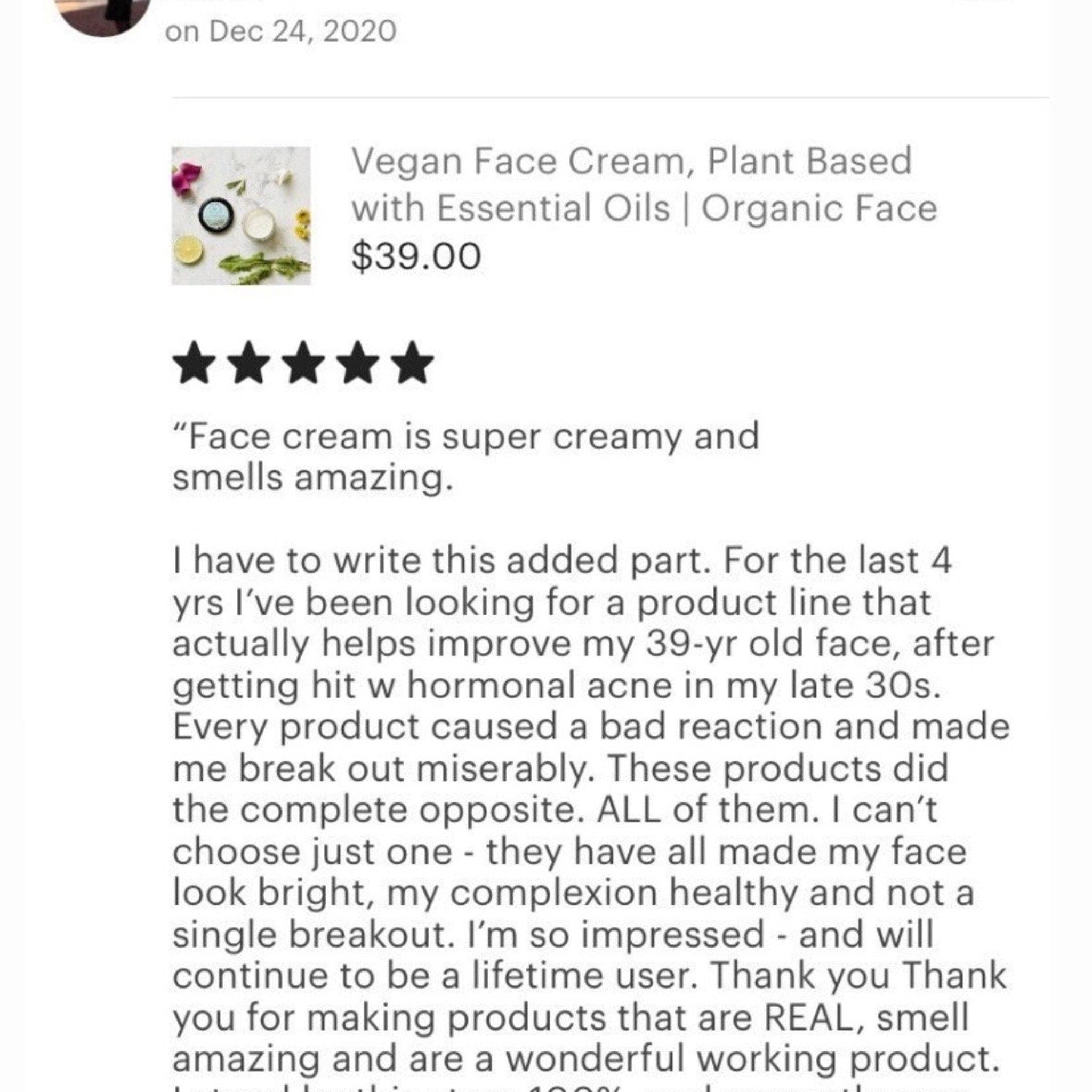 Hand applying vegan face cream with fingertips, showing lightweight texture blending into skin