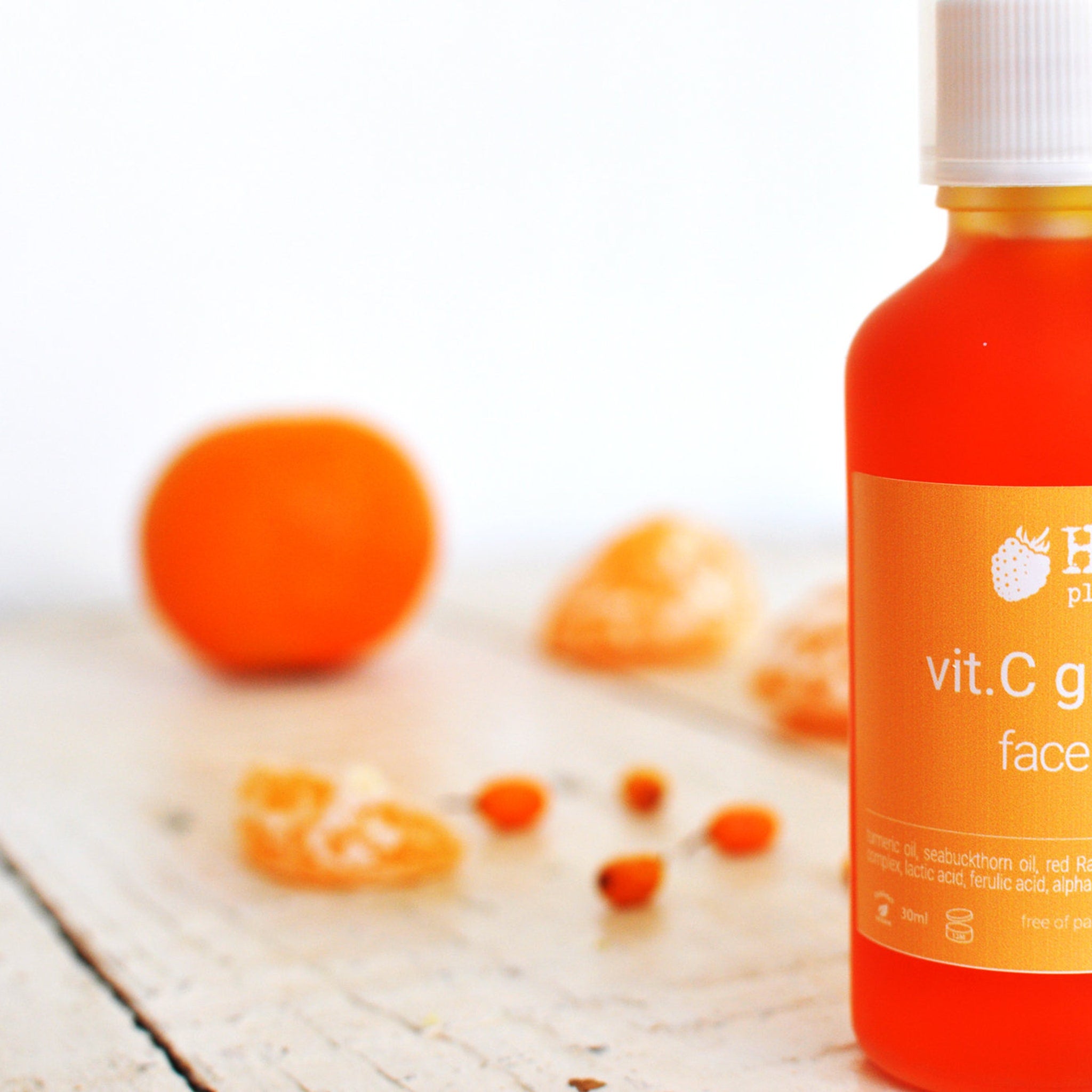 Side view of amber glass bottle with vitamin C serum, showcasing dropper detail and minimalist gold branding