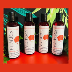 Facial cleanser bottles with black caps, white labels, and F,L,W,R,S brand name