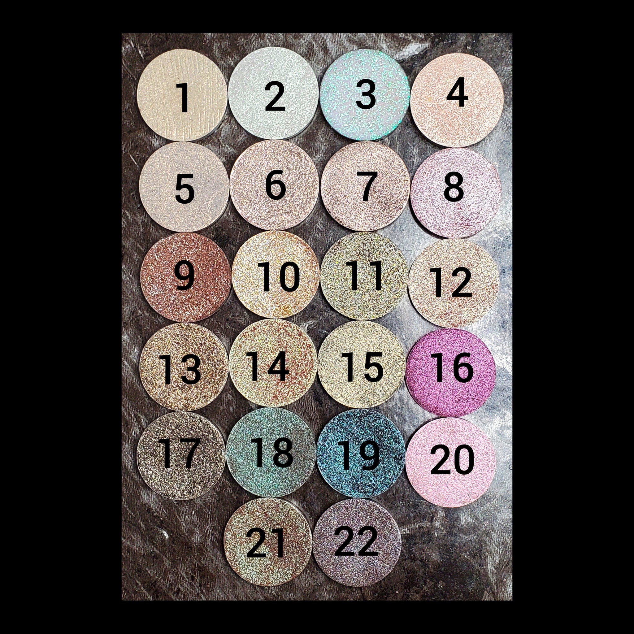 Close-up of duochrome eyeshadow refills showing metallic shift between two vibrant colors in compact palette