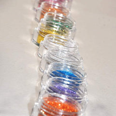 Side view of Wiggins glitter eye shadow jar showing sifter top and reflective silver packaging