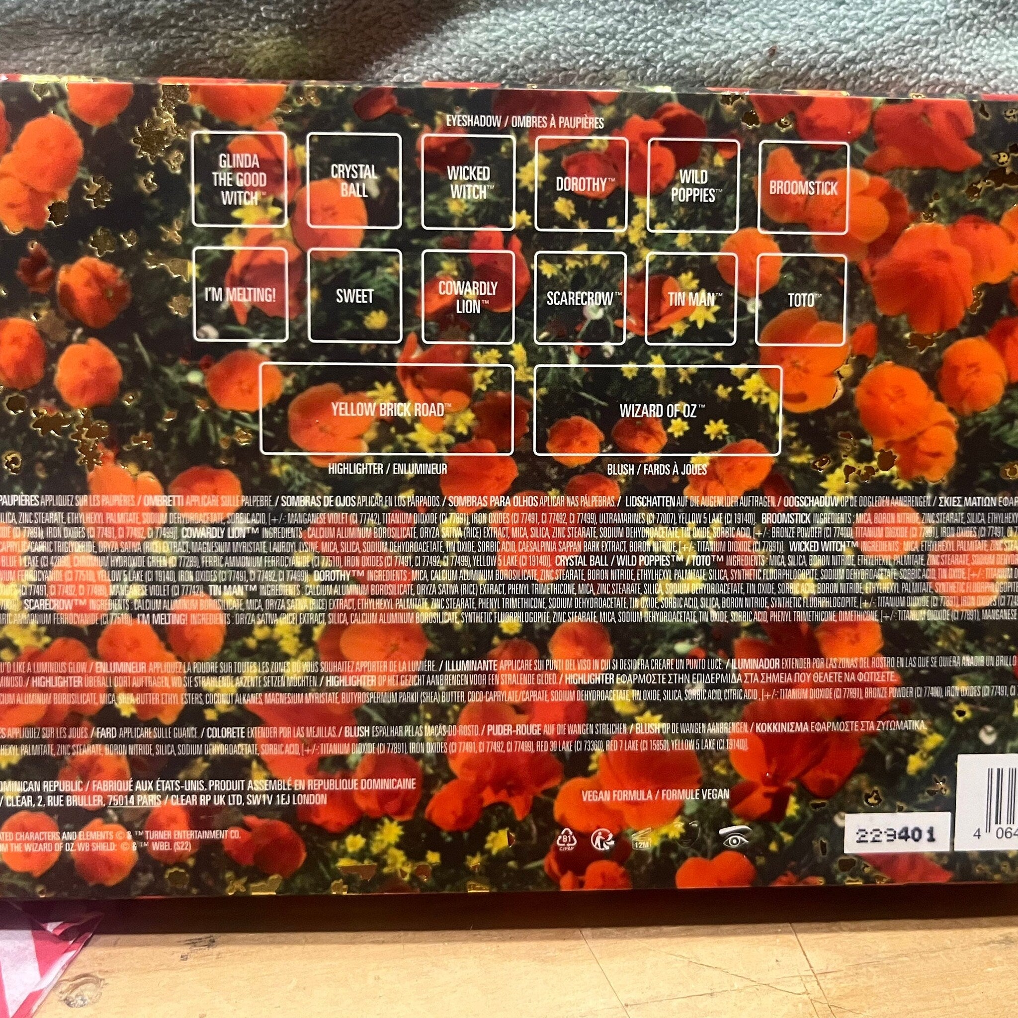 Eyeshadow palette with orange and yellow floral pattern, and text labels.