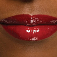 Lip gloss with glossy red finish and dark lip stain, shown on lips
