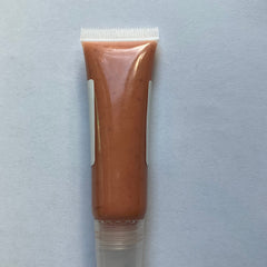 Lip gloss tube with peach color, clear plastic, and white label on a white background