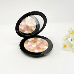 Powder compact with black case, multi-color mosaic pattern, and clear lid open