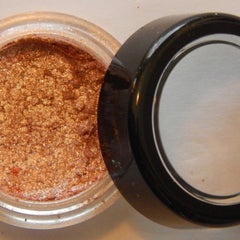 Close-up of Noisette mineral eye shadow showing soft matte texture and warm taupe-brown hue in compact case