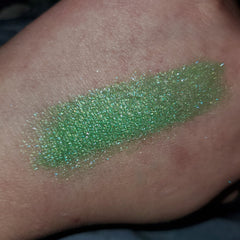 Side view of Attack Eye Shadow compact showcasing sleek black case with angled edges and mirrored finish