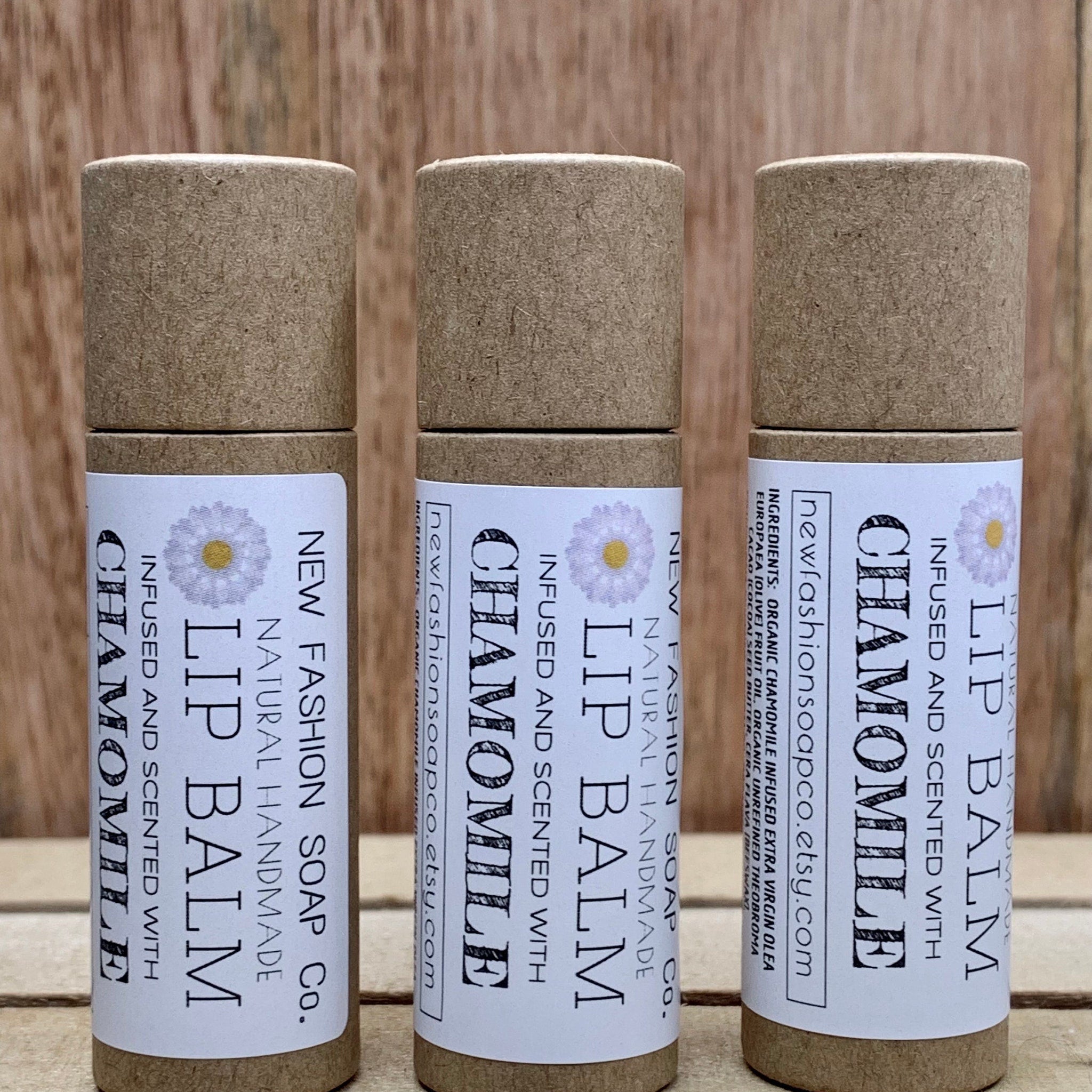 Lip balm tubes, brown cardboard, white label with text and daisy design, New Fashion Soap Co brand