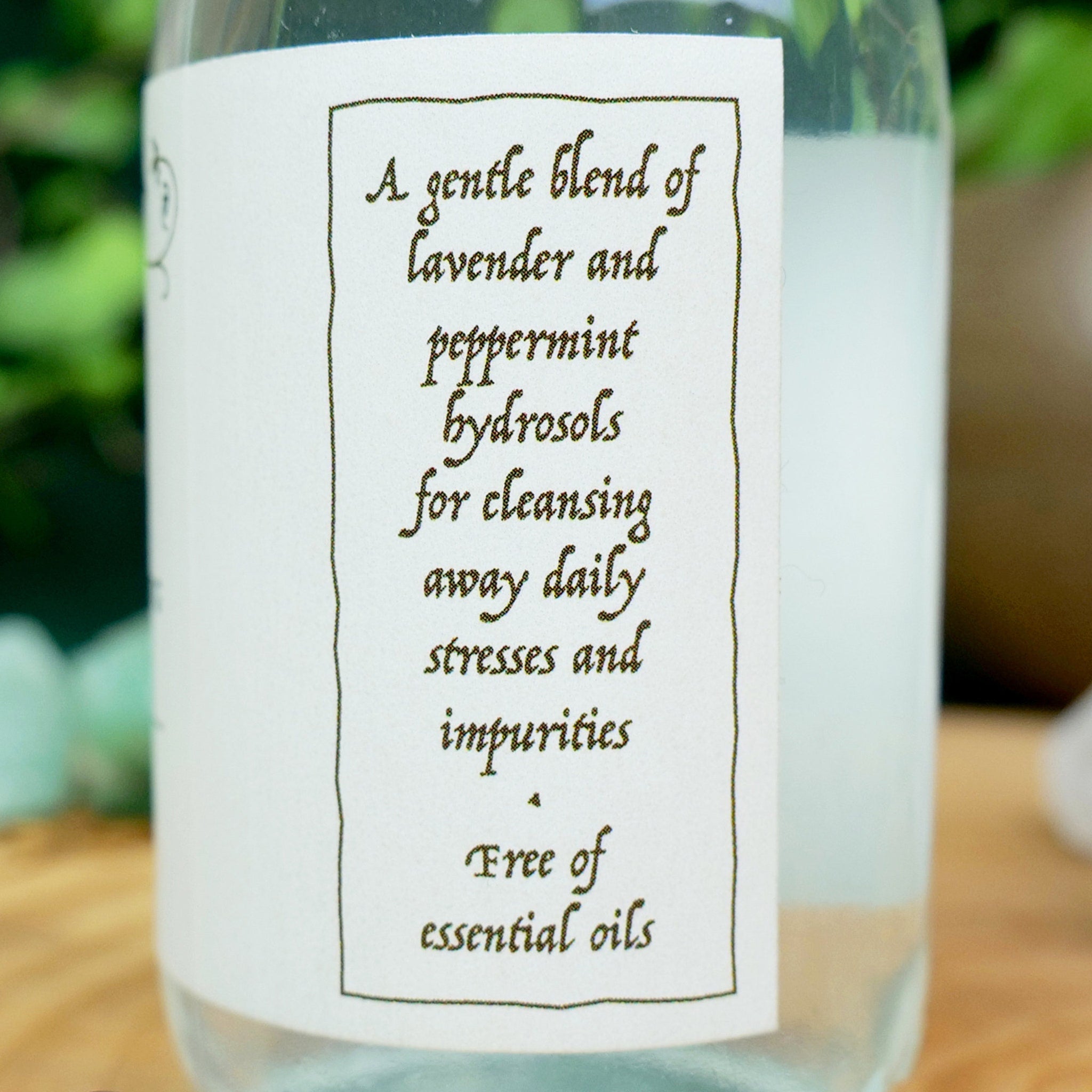 Hydrosol bottle with white label, black text, and clear liquid inside, for cleansing