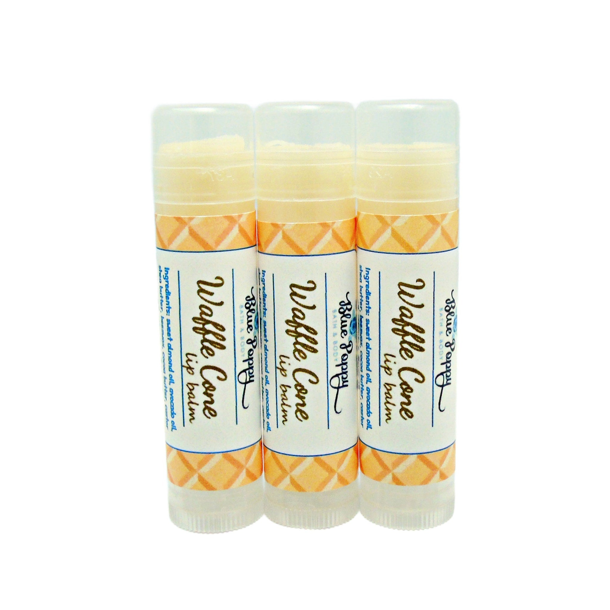 Lip balm tubes, white and orange patterned, with Blue Poppy branding, for lip care