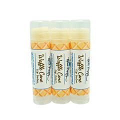 Lip balm tubes, white and orange patterned, with Blue Poppy branding, for lip care