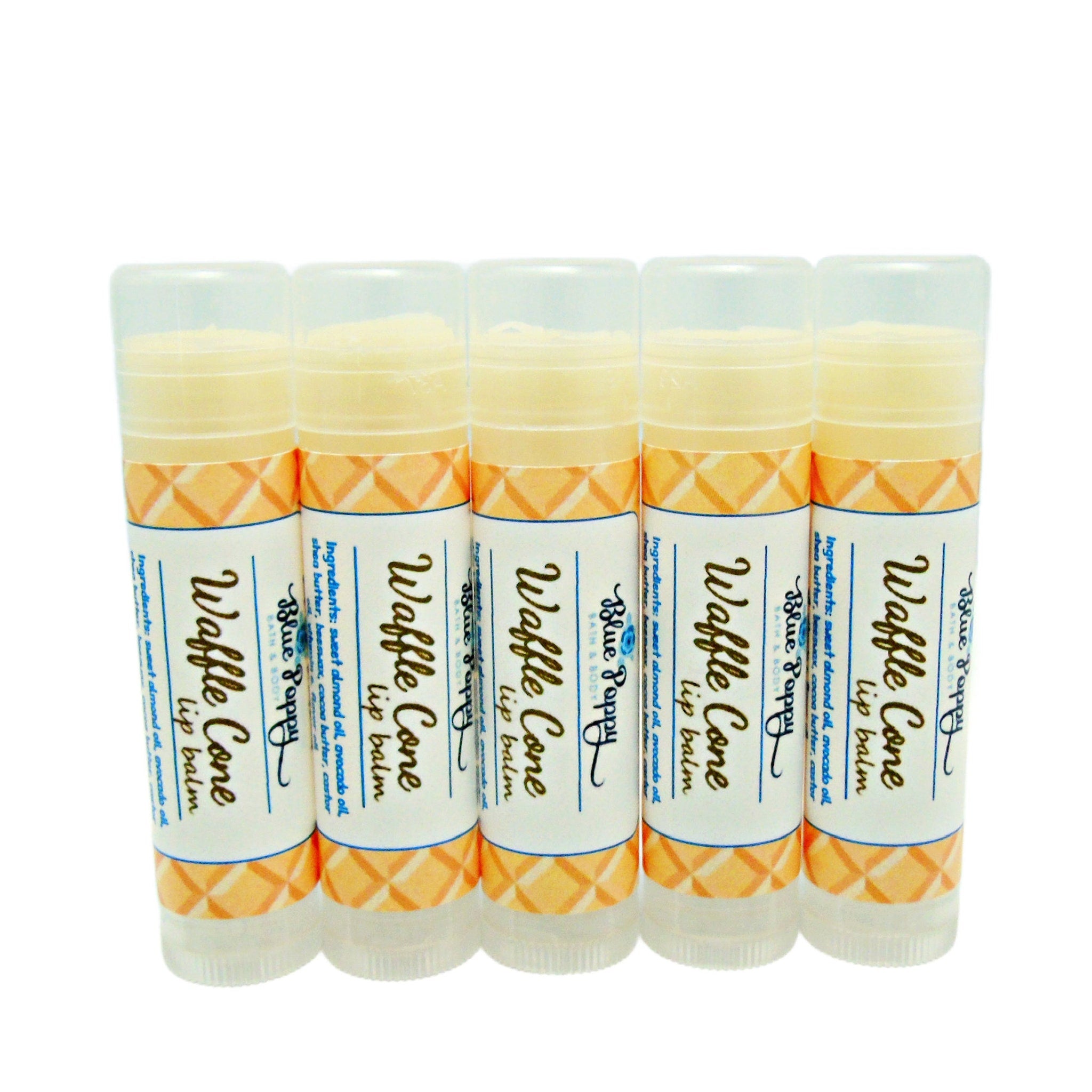 Lip balm tubes with white, orange diamond pattern, and Blue Poppy branding.