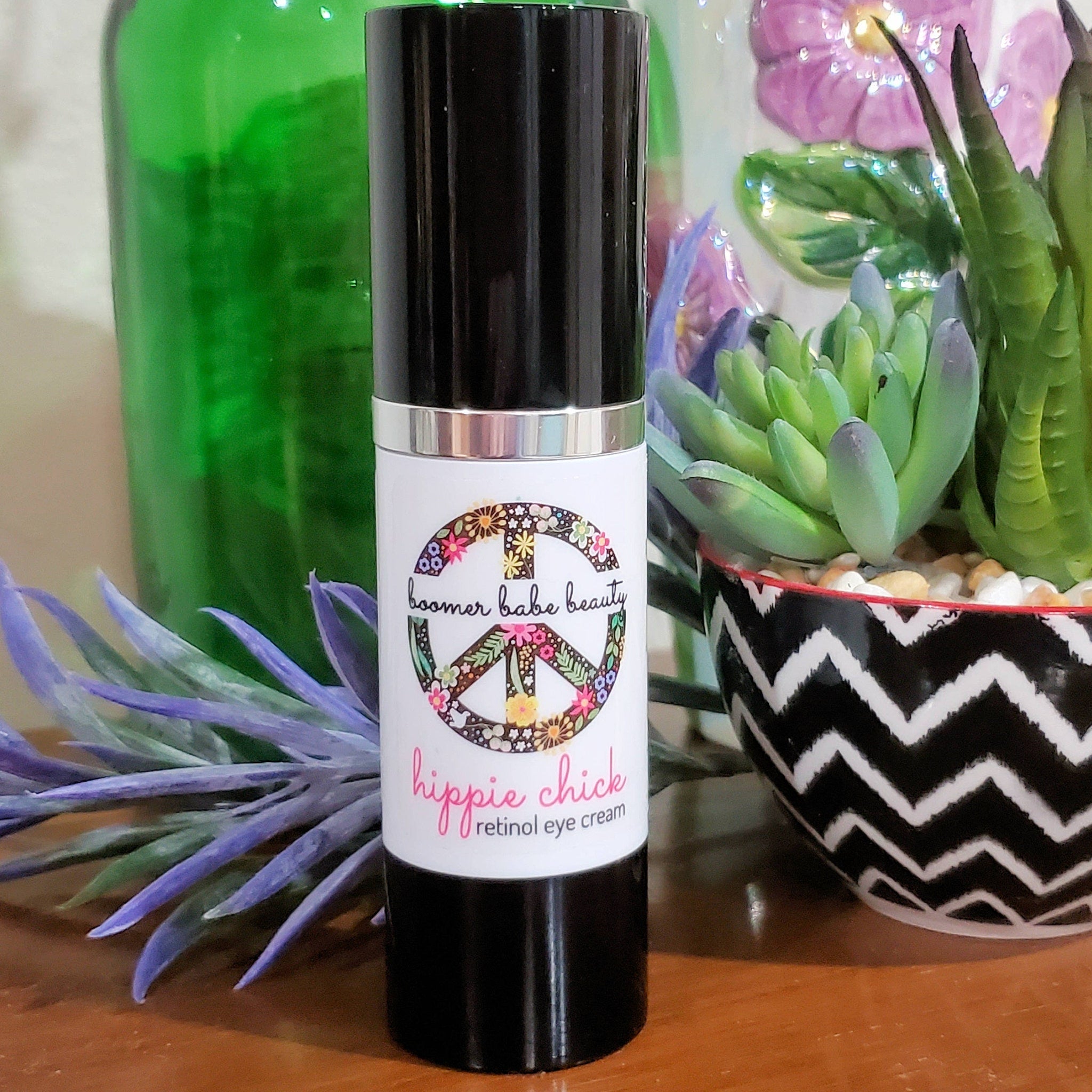 Retinol eye cream, black and white bottle, "Hippie Chick" label with floral peace sign
