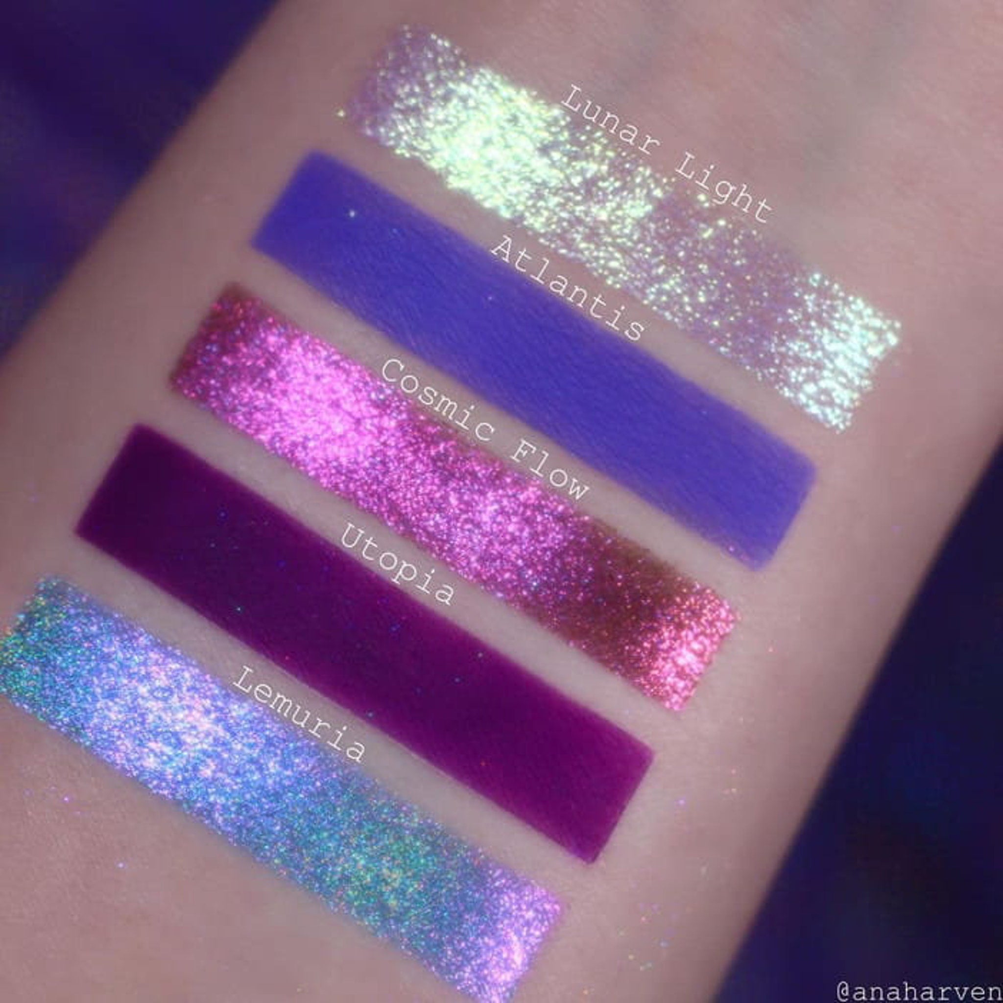 Close-up of duochrome eyeshadows shifting between purple, green, and gold in holographic palette