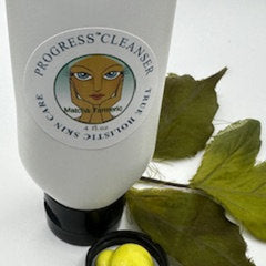 Facial cleanser bottle, white plastic, Progress label, green leaves, black cap