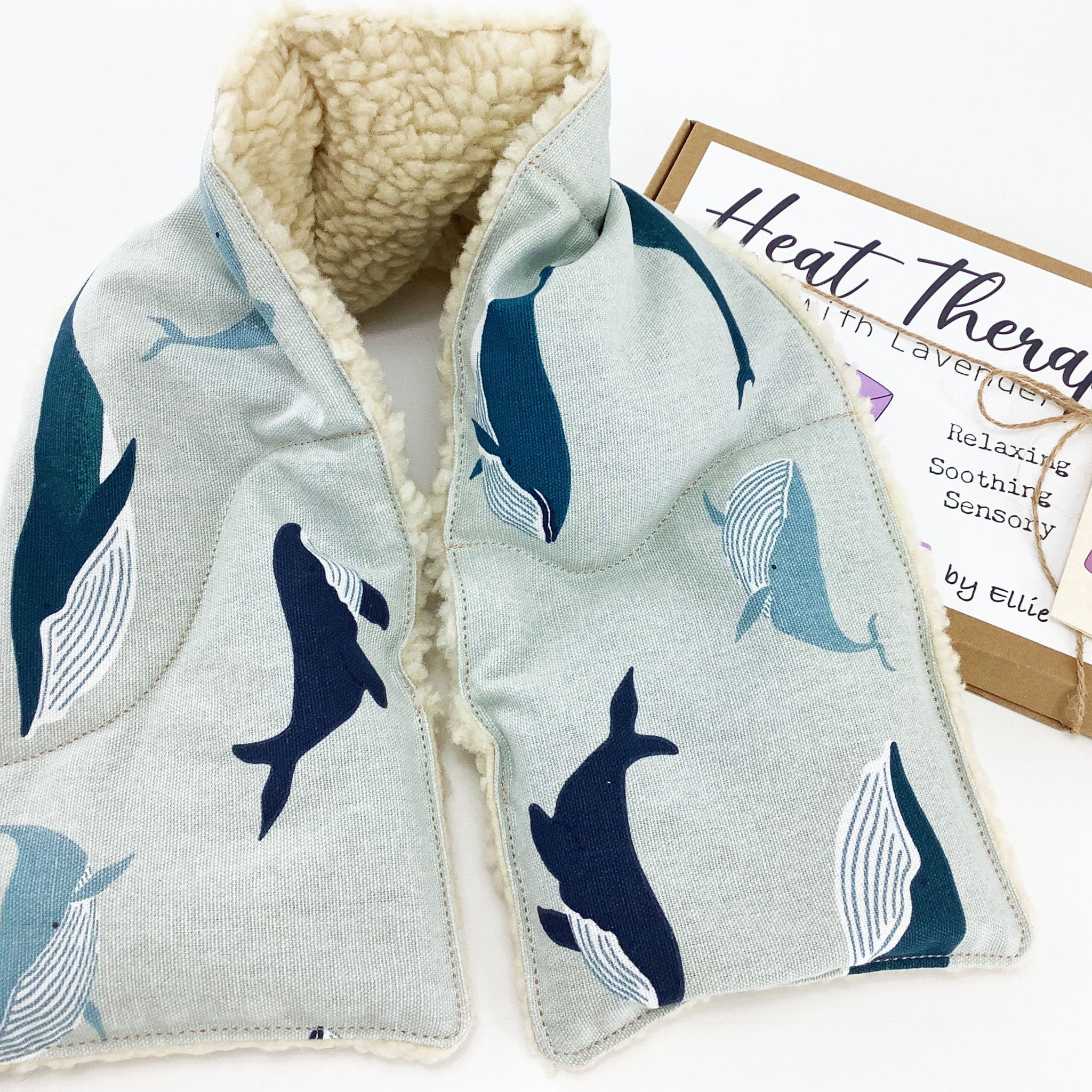 Wheat bag shoulder wrap with whale print, light blue fabric, and fluffy white trim
