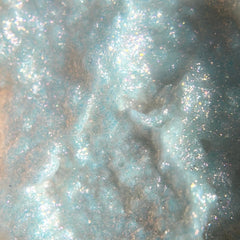 Close-up of sparkly pink iridescent gel liquid eyeshadow with shimmer particles catching light