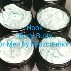 Hand scooping whipped shea butter moisturizer from a sleek white jar, showcasing its creamy texture