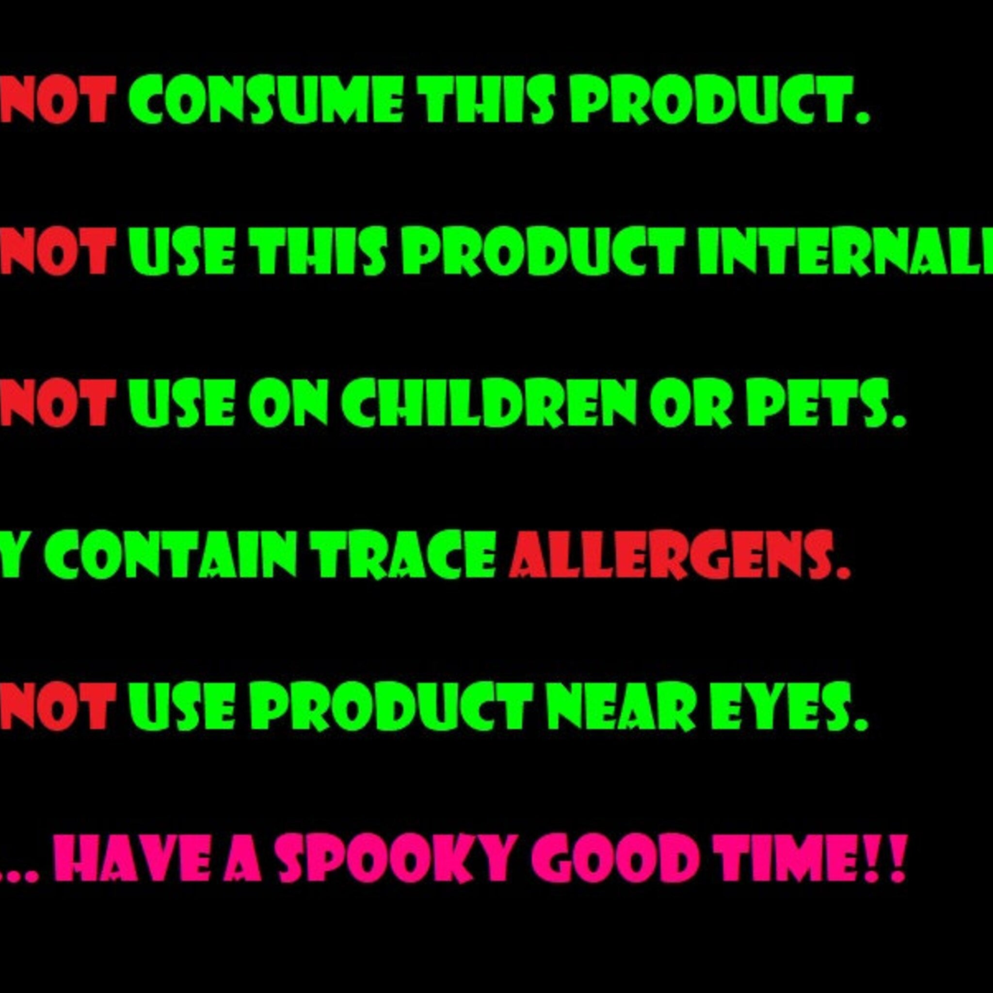 Warning sign with black background, green and red text, and spooky message about use