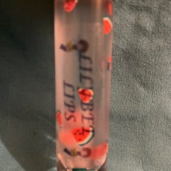 Lip gloss tube with red and green watermelon pattern and "CUTE LIPS" text on clear tube