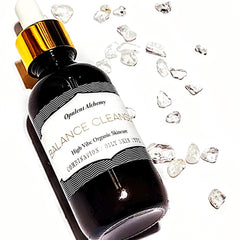 Skincare bottle black glass with gold cap and white label, Opulent Alchemy Balance Cleanse product