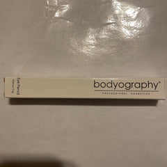 Close-up of Bodyography Black Walnut Eye Pencil showing rich brown shade and sleek wooden-textured packaging