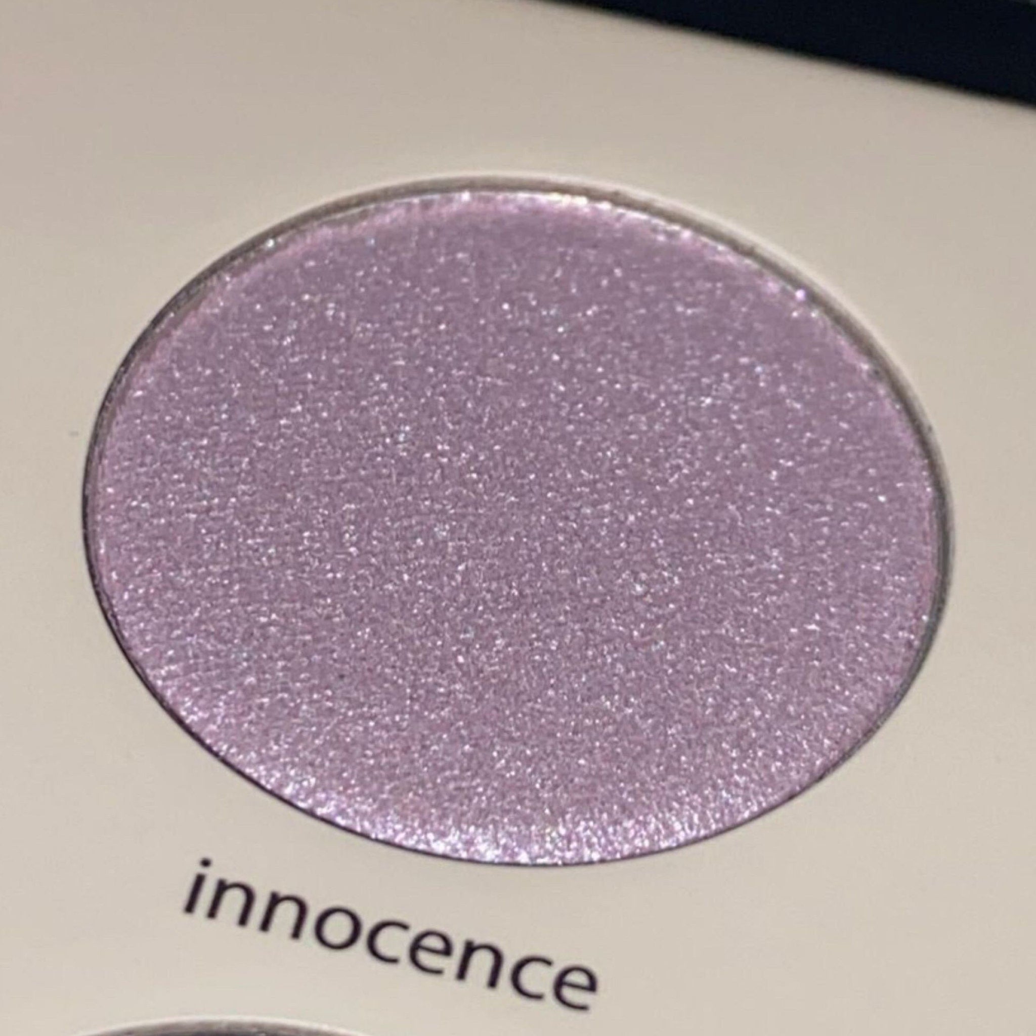 Eyeshadow, light purple shimmer, round compact, innocence text visible