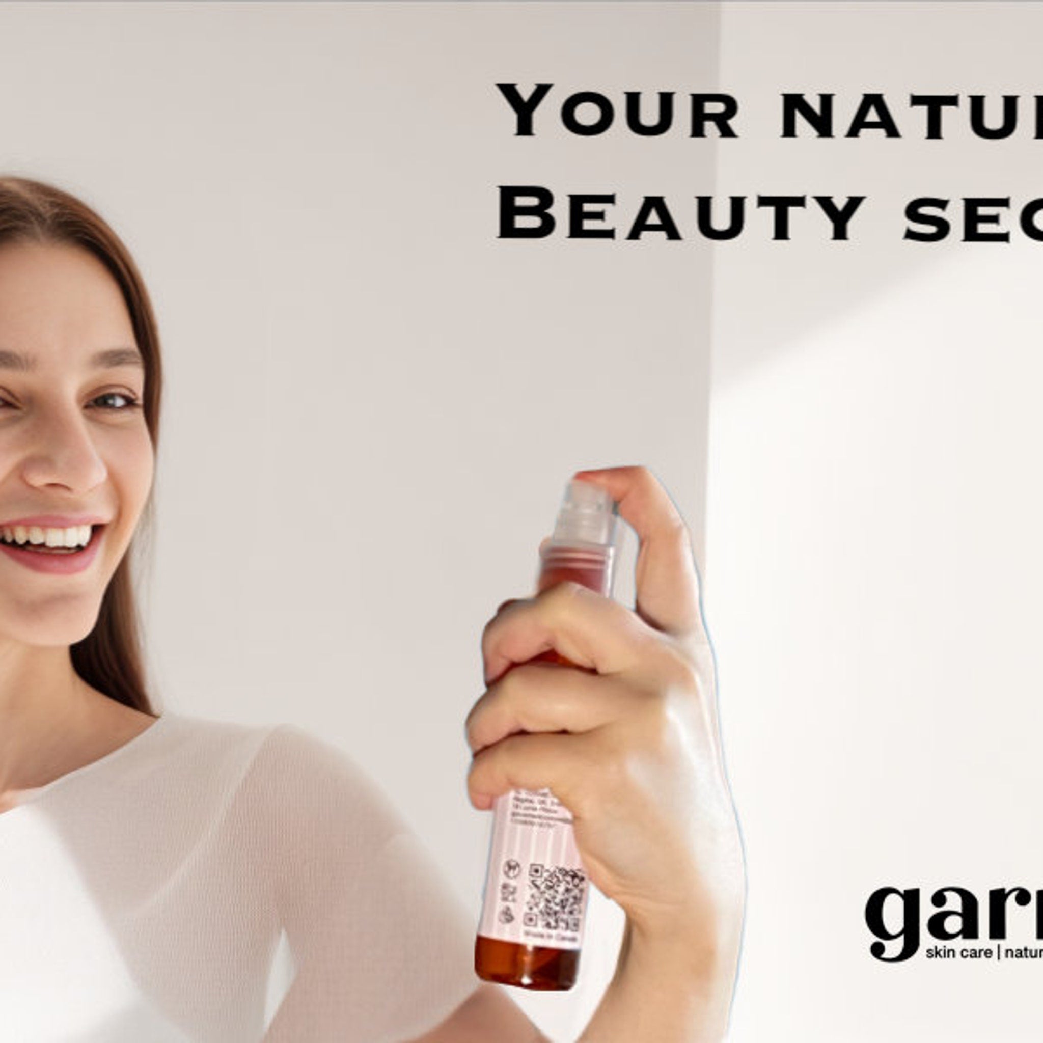 Facial spray bottle held by woman, brown and clear bottle, white label, garni skin care text