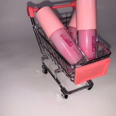 Lip balms in pink tubes and glass bottles, in a miniature shopping cart, Pinky Cosmetics visible