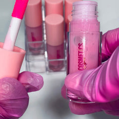Lip gloss tubes with pink liquid, pink applicator, and pink "COSMETICS" text