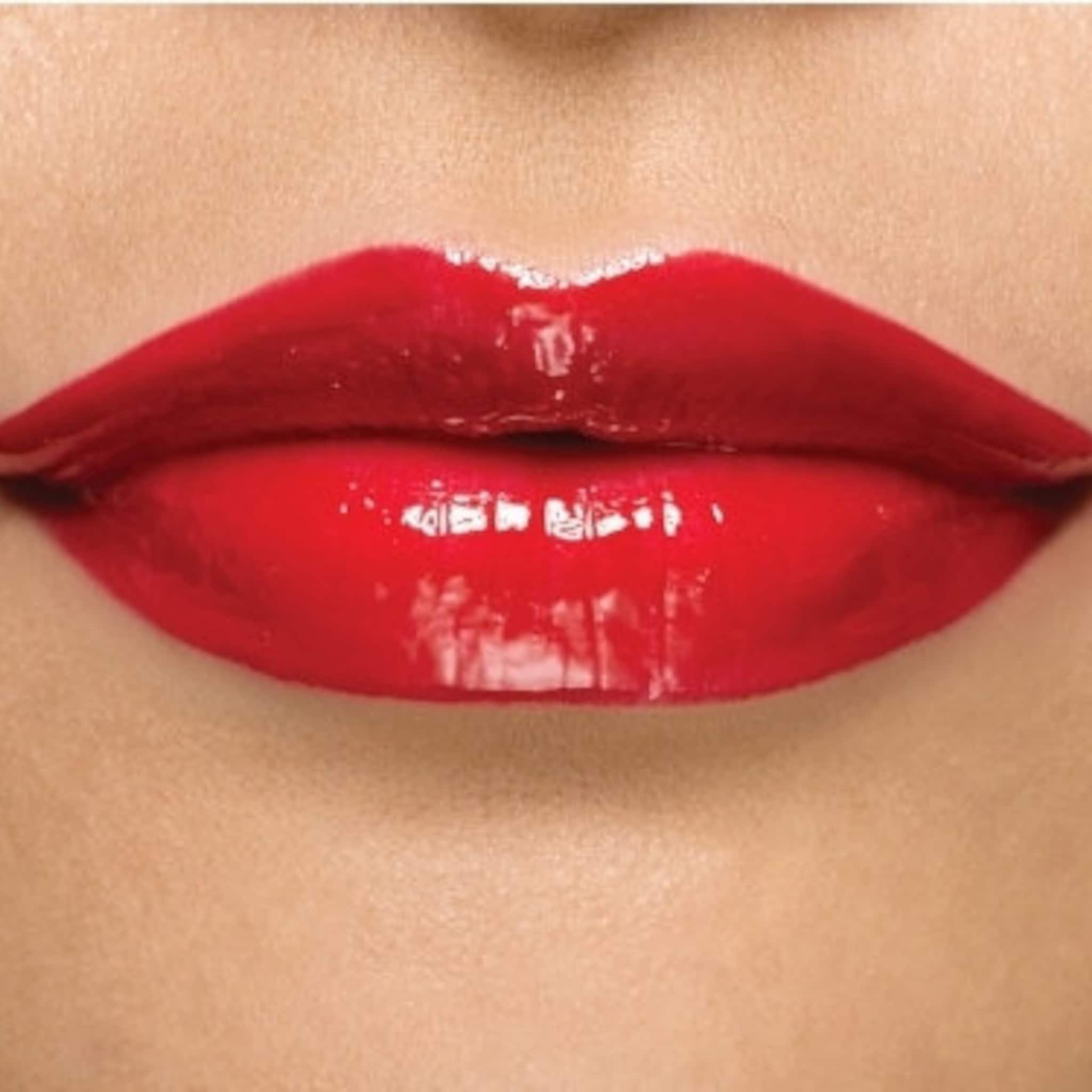 Red glossy lips with visible skin texture, close-up view