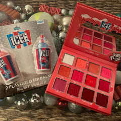 Close-up of cherry red and pink shimmer eyeshadows in Glamlite ICEE palette with glossy lip balm