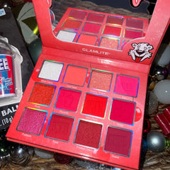 Side view of Glamlite ICEE Cherry palette showing vibrant pink and red eyeshadows with glossy lip balm