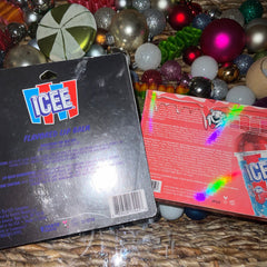 Close-up of a makeup brush applying shimmery cherry red eyeshadow from the Glamlite ICEE palette