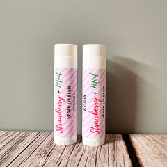 Lip balm tubes with pink and white striped pattern, brand name Kosha visible, on wooden surface