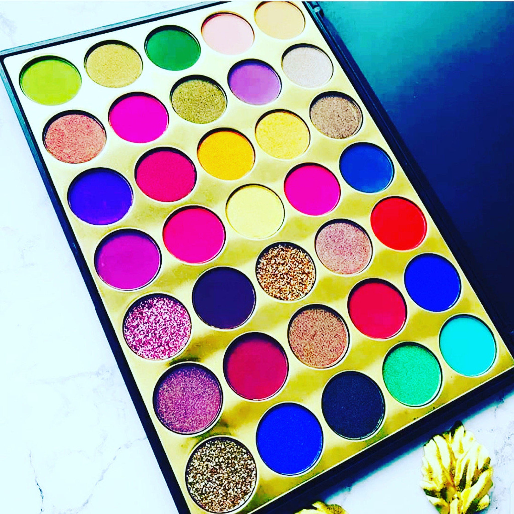Royal Eyeshadow Palette with shimmering jewel-toned shades in a sleek black compact case