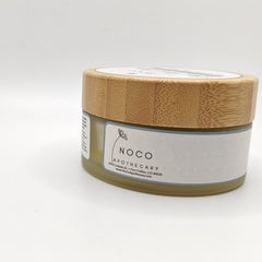 Jar with bamboo lid, green glass, and NOCO APOTHECARY label with geometric pattern