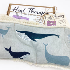 Heat therapy wrap with whale print, light blue fabric, and white fleece trim