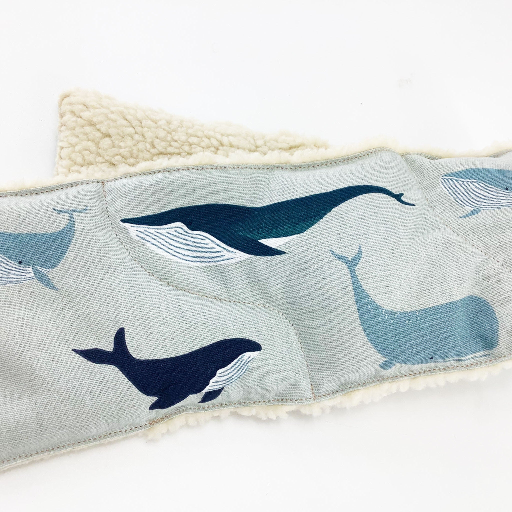 Whale print fabric with blue whales, light blue background, and cream sherpa trim