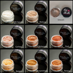 Side view of mineral eye shadow jar showing textured powder surface in natural earthy tones