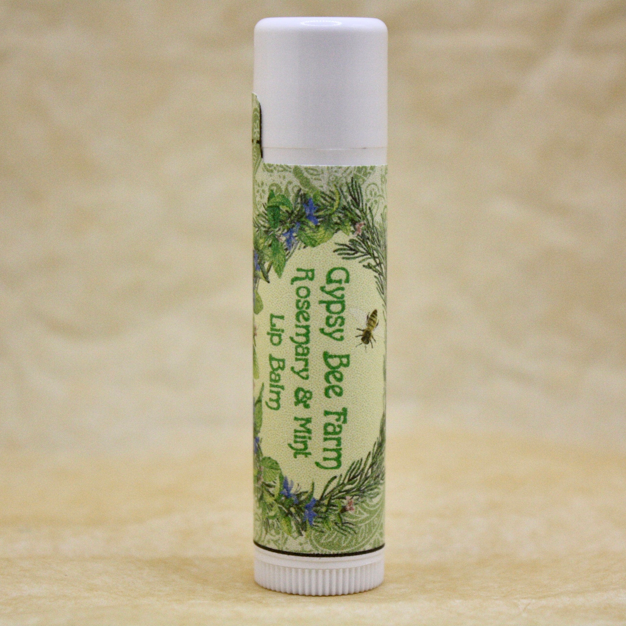 Lip balm tube with white cap, green label, and Gypsy Bee Farm text