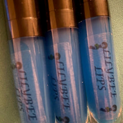 Lip gloss tubes, blue liquid, black caps, "Ellybte Lips" text, clear plastic tubes