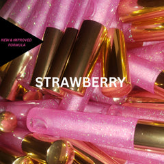 Lip gloss tubes, pink glitter, gold caps, strawberry flavor text visible