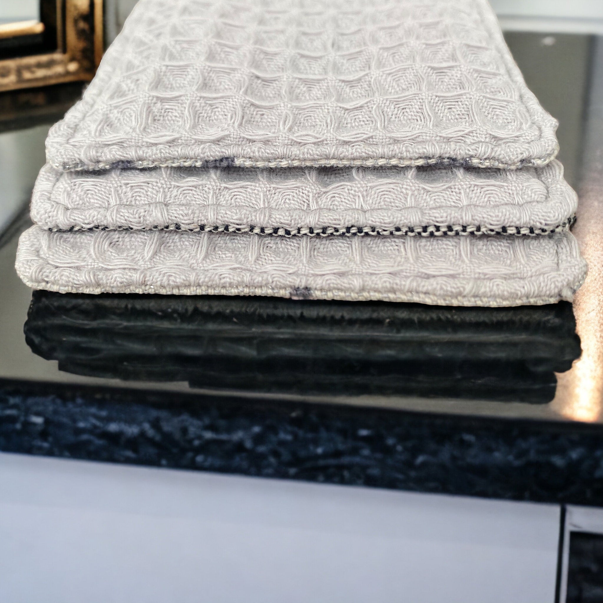 Waffle weave towels, light gray, textured, folded on countertop