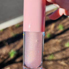 Cotton candy lip gloss with pink cap, clear tube, and iridescent glitter